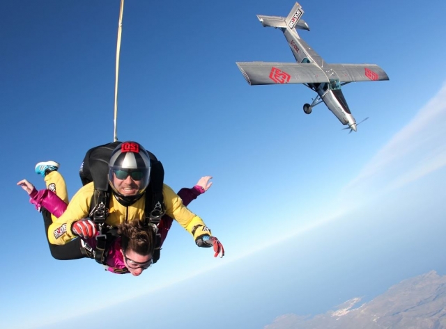  Parachutists leaving the plane behind 